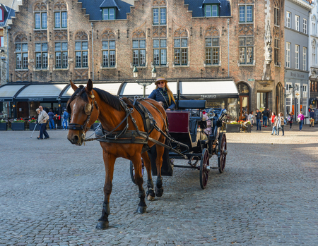 Bruges, Belgium - Oct 5, 2018. Horse cart in Bruges (Brugge), Belgium. Bruges is distinguished by its canals, cobbled streets and medieval buildings.のeditorial素材