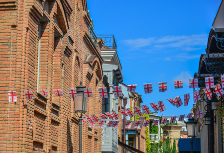 Brick houses with hanging national flags at Ancient Town of Tbilisi, Georgia.のeditorial素材