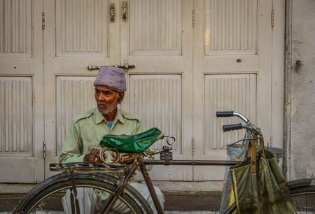 Jodhpur, India - Nov 6, 2017. An old man with bicycle on street in Jodhpur, India. Jodhpur is the second largest city in state of Rajasthan.のeditorial素材