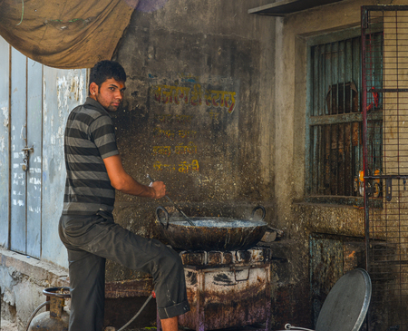 Jodhpur, India - Nov 6, 2017. A man cooking traditional food on street in Jodhpur, India. Jodhpur is the second largest city in state of Rajasthan.のeditorial素材