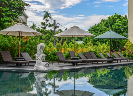 Hoi An, Vietnam - Jul 20, 2018. Swimming pool of luxury resort in Hoi An, Vietnam. Hoi An is a city...