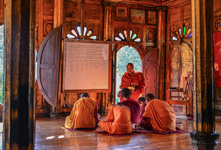 Nyaungshwe, Myanmar - Feb 8, 2017. Young Samaneras (novice monks) sitting and studying in prayer...
