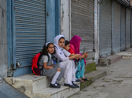 Srinagar, India - Jul 24, 2015. Muslim students waiting for the bus on street in Srinagar, India. Srinagar is the summer capital of Jammu and Kashmir.のeditorial素材