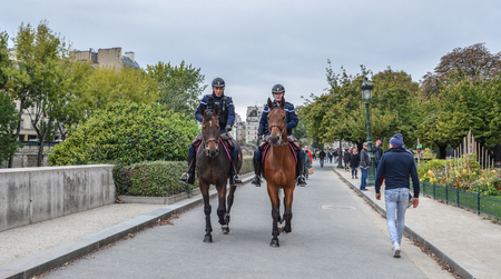 Paris, France - Oct 2, 2018. Gendarmes on horseback in Paris, France. The National Gendarmerie is one of two national police forces of France.のeditorial素材