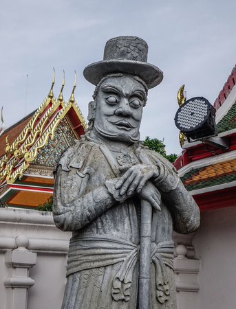 Chinese guardian figure beside a gate in Wat Pho. Wat Pho is one of the largest and oldest wats in Bangkok, Thailand.の写真素材