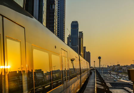 Dubai, UAE - Dec 10, 2018. A metro train running on track at sunset. The Dubai Metro is a driverless, fully automated metro rail network.のeditorial素材