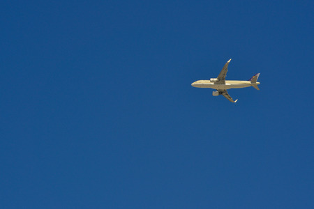 Passenger airplane flying in the blue sky. Aviation background with copy space.のeditorial素材