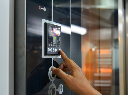 Saigon, Vietnam - Jan 9, 2019. A man hand with electric oven at the bakery in Saigon, Vietnam.のeditorial素材