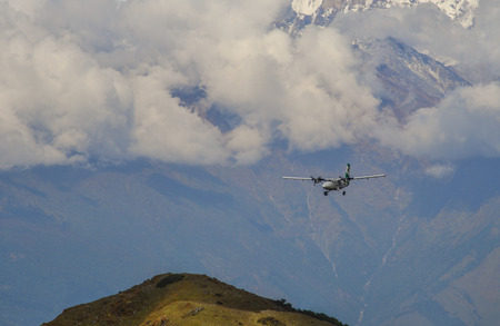 Khopra, Nepal - Oct 25, 2017. A passenger airplane flying over the mountains of Annapurna Massif, Nepal.のeditorial素材