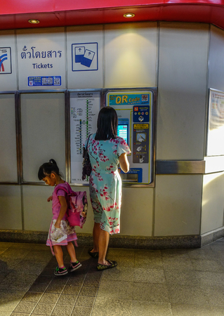 Bangkok, Thailand - Dec 25, 2018. People buying train ticket for public transport at the automatic ticket machine in BTS Station.のeditorial素材