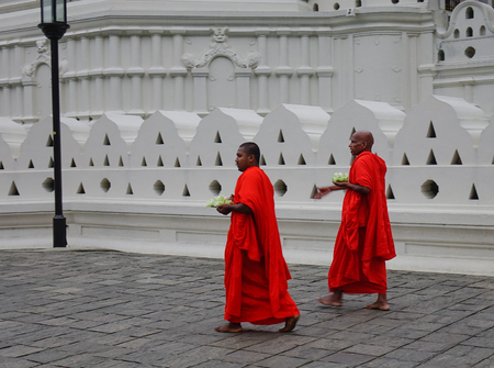 Kandy, Sri Lanka - Dec 15, 2018. Buddhist monks in bright orange robe visit Temple of the Sacred Tooth Relic in Kandy, Sri Lanka.のeditorial素材