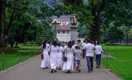 Kandy, Sri Lanka - Dec 15, 2018. White clothed Buddhist devotees visit Temple of the Sacred Tooth Relic in Kandy, Sri Lanka.のeditorial素材
