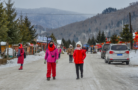 Harbin, China - Feb 24, 2018. People walking on main street of mountain town at winter in Harbin, China.のeditorial素材