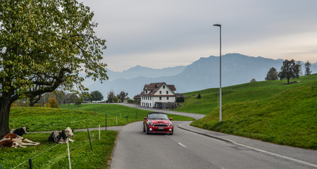 Lucerne, Switzerland - Oct 23, 2018. Car running on rural road with beautiful landscape at summer in Lucerne, Switzerland.のeditorial素材