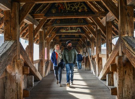 Lucerne, Switzerland - Oct 23, 2018. People walking on Chapel Bridge (Kapellbrucke). The bridge is a covered wooden footbridge spanning the River Reuss.のeditorial素材