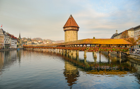 Lucerne, Switzerland - Oct 23, 2018. Sunset scenery of Chapel Bridge in Lucerne. The bridge is unique in containing a number of paintings dating back to the 17th century.のeditorial素材
