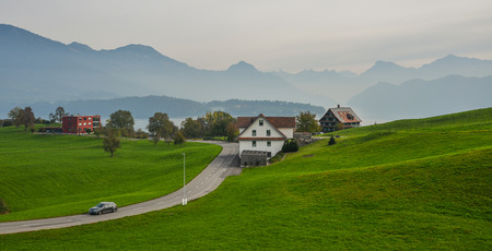Lucerne, Switzerland - Oct 23, 2018. Car running on rural road with beautiful landscape at summer in Lucerne, Switzerland.のeditorial素材