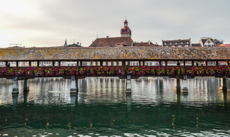 Lucerne, Switzerland - Oct 23, 2018. Sunset scenery of Chapel Bridge in Lucerne. The bridge is unique in containing a number of paintings dating back to the 17th century.のeditorial素材