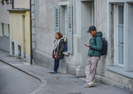 Lucerne, Switzerland - Oct 23, 2018. People standing on the street of Lucerne city along Reuss river coast (Switzerland).のeditorial素材