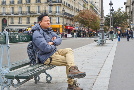 Paris, France - Oct 2, 2018. A man sitting on vintage bench in Paris, France. Paris was ranked as the third most visited travel destination in the world in 2017.のeditorial素材