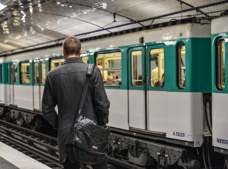 Paris, France - Oct 3, 2018. A man waiting at Metro station in Paris, France. Paris Metro is one of largest underground system in the world.のeditorial素材