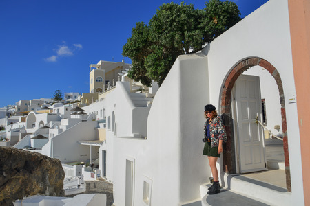 Asian young woman enjoying at sunny day on Santorini Island, Greece.のeditorial素材