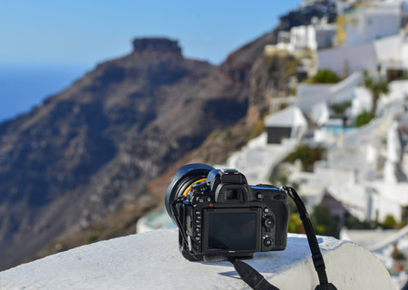Santorini, Greece - Oct 4, 2018. A Nikon D750 DSLR camera with lens on the white balcony at Oia Village in Santorini Island, Greece.のeditorial素材