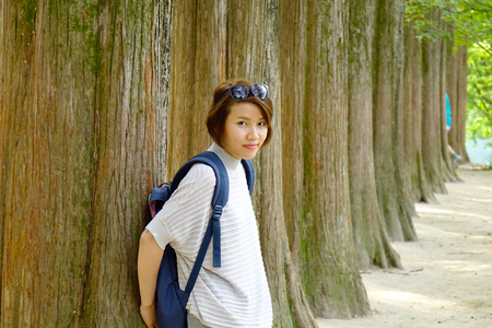 Young Asian woman standing at the tree park on Nami Island, South Korea.のeditorial素材