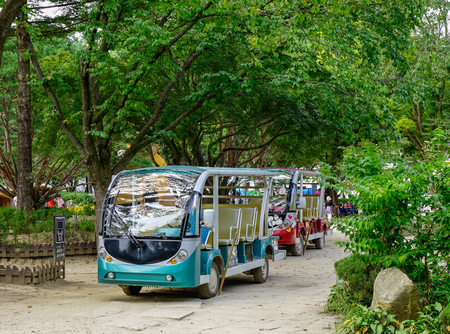 Nami, South Korea - Feb 6, 2015. Electric carts waiting for passengers in front of the botanic garden on Nami Island, South Korea.のeditorial素材