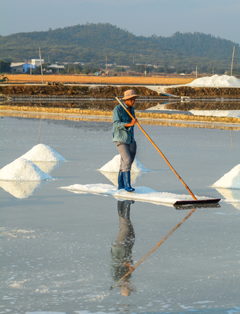 Nha Trang, Vietnam - Mar 21, 2016. People working on salt field at summer in Nha Trang, Vietnam. Salt fields is one of the most unique destinations in Nha Trang.のeditorial素材