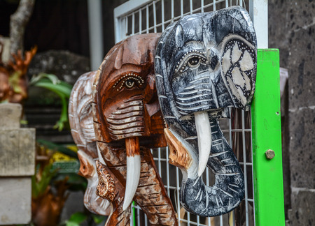 Lots of carved wooden elephants for sale at souvenir shop.の写真素材