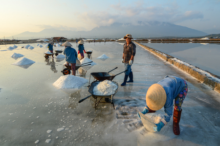 Nha Trang, Vietnam - Mar 21, 2016. People working on salt field at summer in Nha Trang, Vietnam. Salt fields is one of the most unique destinations in Nha Trang.のeditorial素材