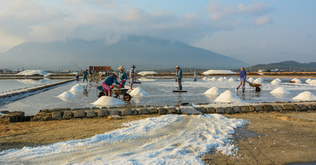 Nha Trang, Vietnam - Mar 21, 2016. People working on salt field at summer in Nha Trang, Vietnam. Salt fields is one of the most unique destinations in Nha Trang.のeditorial素材