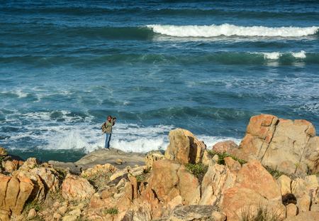 Nha Trang, Vietnam - Jan 27, 2016. A photographer taking pictures of the sea in Nha Trang, Vietnam. Nha Trang is a coastal city on the South Central Coast of Vietnam.のeditorial素材