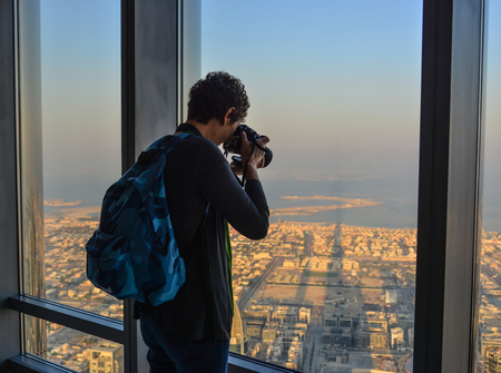 Dubai, UAE - Dec 7, 2018. A man enjoying at the observation deck of the highest building in the world, Burj al Khalifa.のeditorial素材