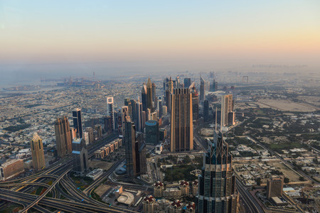 Dubai, UAE - Dec 7, 2018. Aerial view of Dubai City at sunrise. View on the rooftop of Burj Khalifa...