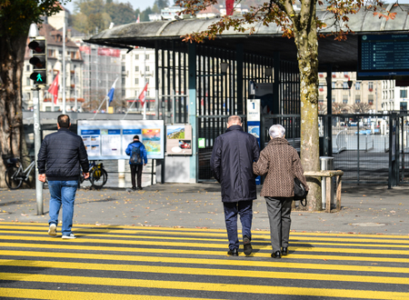 Lucerne, Switzerland - Oct 23, 2018. People walking on the street of Lucerne city along Reuss river coast (Switzerland).のeditorial素材