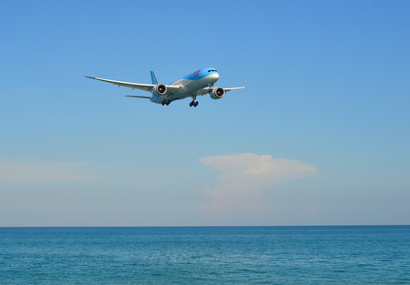Phuket, Thailand - Apr 4, 2019. TUI Airways Boeing 787-9 Dreamliner (G-TUIJ) landing above the sand beach near Phuket Airport (HKT).のeditorial素材
