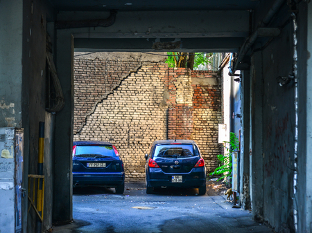 Tbilisi, Georgia - Sep 23, 2018. Cars parking at the old brick house in Tbilisi, Georgia.のeditorial素材