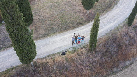Tuscany, Italy - Oct 17, 2018. Group of friends flying a drone on the hill in Tuscany, Italy.のeditorial素材