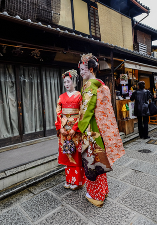 Kyoto, Japan - Nov 20, 2016. Japanese women wearing traditional dress (Kimono) on the historic street in downtown of Kyoto, Japan.のeditorial素材