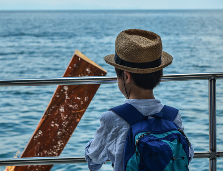 Phuket, Thailand - May 2, 2018. A little boy traveler looking at the sea in Phuket, Thailand. Phuket is Thailand largest island, and another 32 smaller islands off its coast.のeditorial素材
