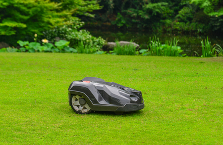 Nagoya, Japan - Jun 29, 2019. Automatic lawn mower robot moves on the grass at botanic garden.のeditorial素材