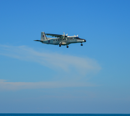 Phuket, Thailand - Apr 4, 2019. Royal Thai Navy Dornier Do-228 (reg. 1112) landing above the sand beach near Phuket Airport (HKT).のeditorial素材