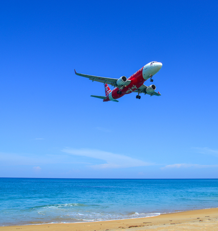 Phuket, Thailand - Apr 4, 2019. HS-BBM Thai AirAsia Airbus A320 landing above the sand beach near Phuket Airport (HKT).のeditorial素材