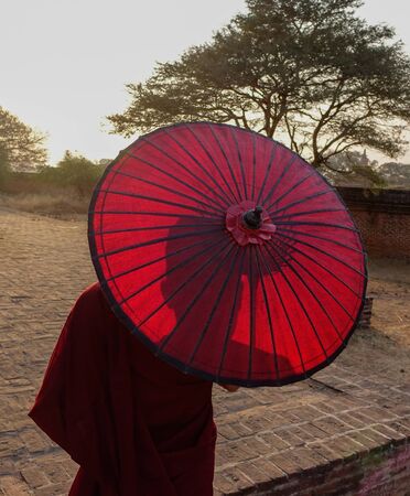 A young monk standing at Buddhist pagoda in Bagan, Myanmar.の写真素材