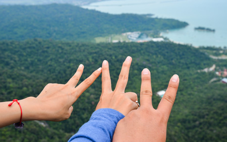 Hands reaching out to green hills in summer mountains.のeditorial素材