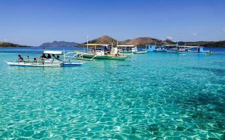 Palawan, Philippines - Apr 11, 2017. Many tourist boats docking on the sea at sunny day in Palawan, Philippines. The Palawan coast is one of the most unspoilt places in the world.のeditorial素材