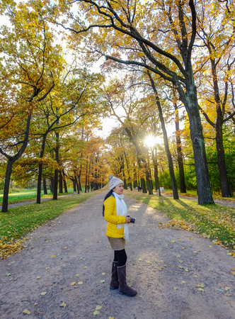 An Asian woman walking at autumn garden in Saint Petersburg, Russia.のeditorial素材