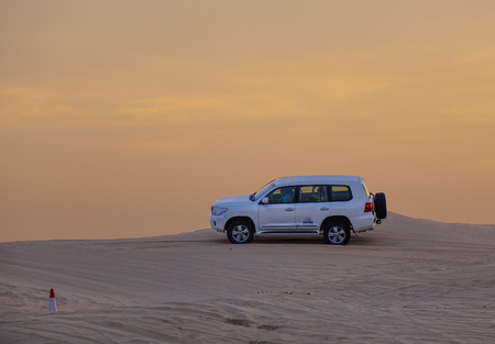 Dubai, UAE - Dec 5, 2018. SUV car (4x4) on Dubai desert. Driving in the desert sand dune is a popular activity among tourists in Dubai.のeditorial素材